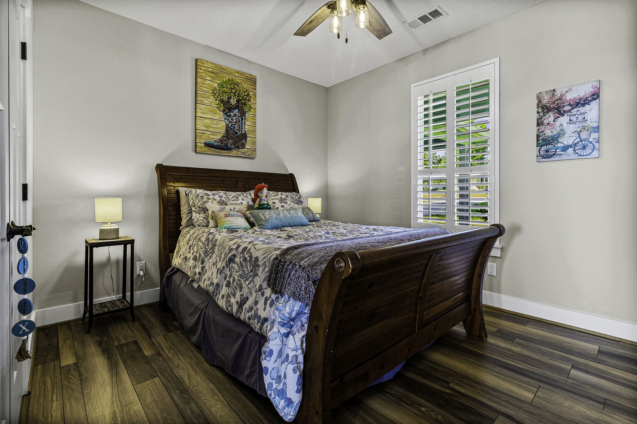 151 Key Largo Loop Point Blank, TX 77364 - Photo 23 of 49 Inviting guest bedroom with plantation shutter, wood flooring, and war, relaxing atmosphere.