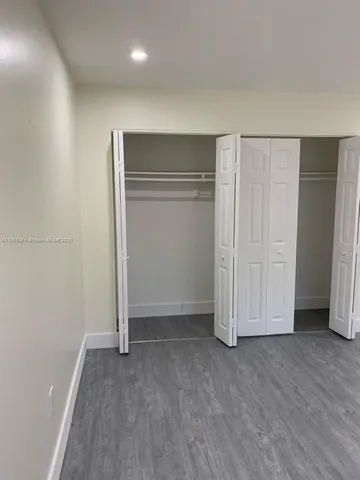 an empty room with closet area