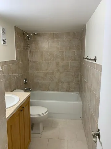 a bathroom with a shower a toilet and a sink