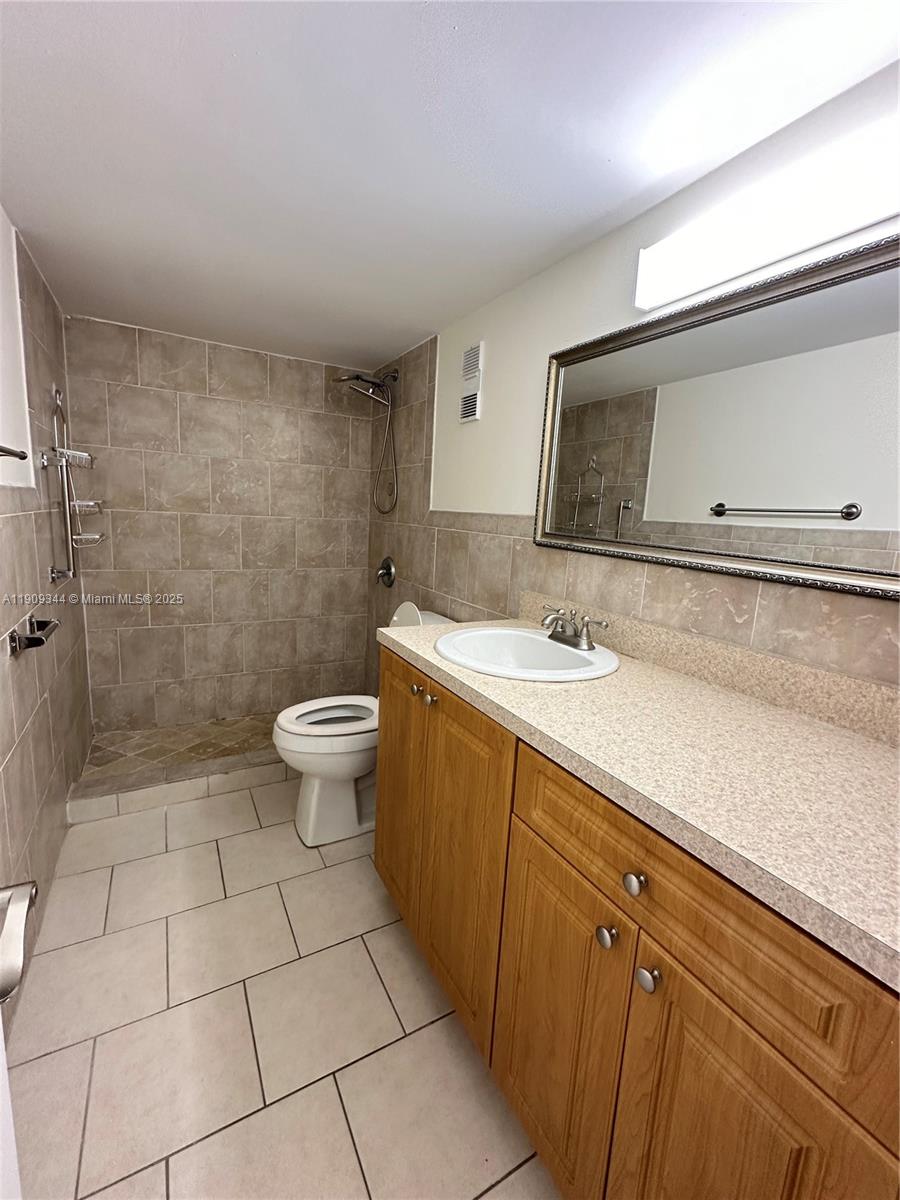 1555 West 44th Place, Unit 234 Hialeah, FL 33012 - Photo 28 of 38 a bathroom with a sink a toilet and shower