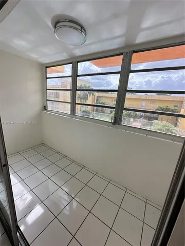 a view of an empty room and a hallway