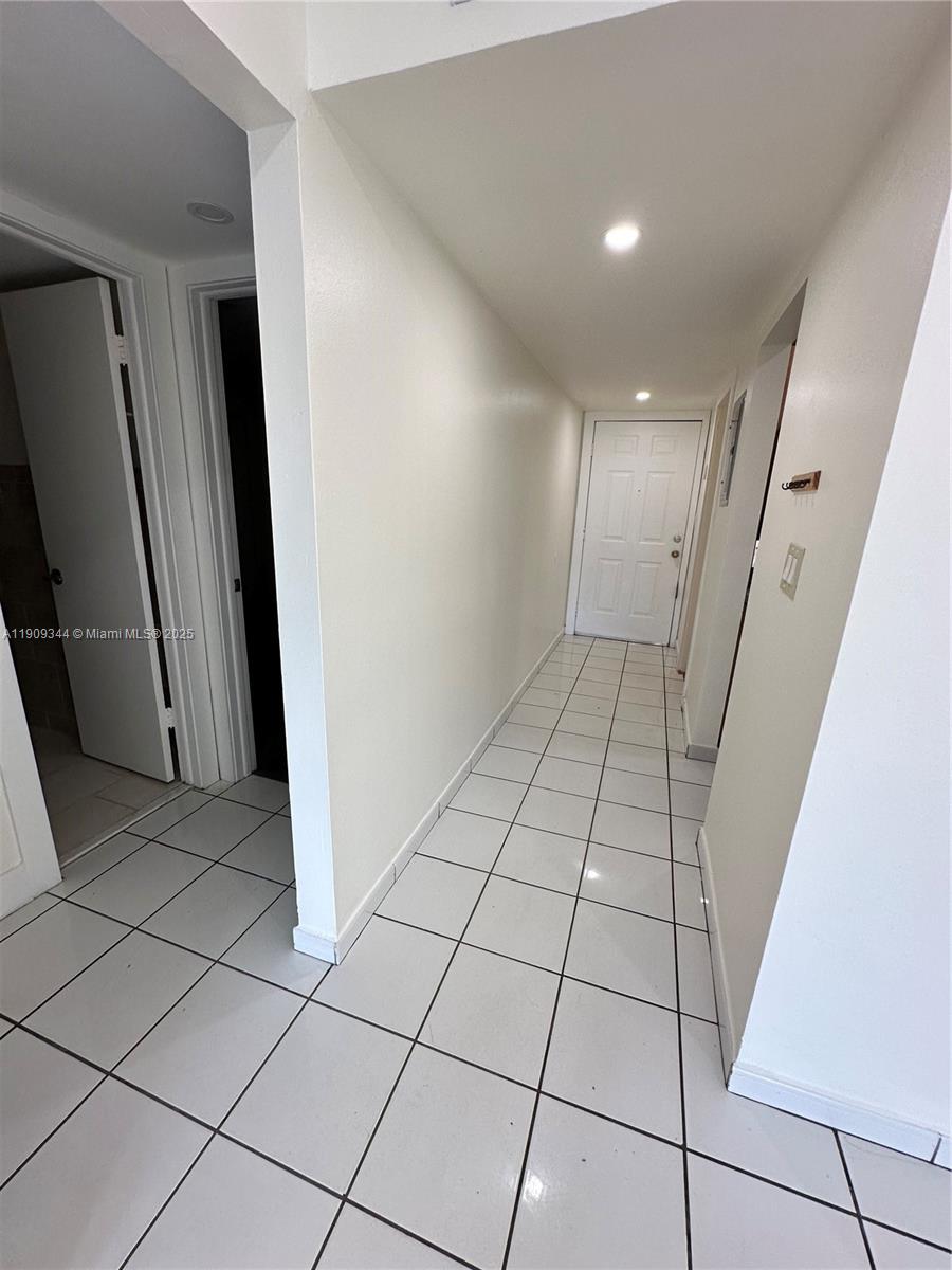 1555 West 44th Place, Unit 234 Hialeah, FL 33012 - Photo 33 of 38 a view of an empty room and a hallway