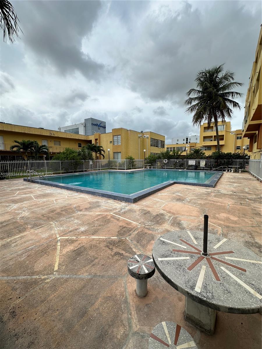 1555 West 44th Place, Unit 234 Hialeah, FL 33012 - Photo 38 of 38 a view of a swimming pool with a patio and a yard