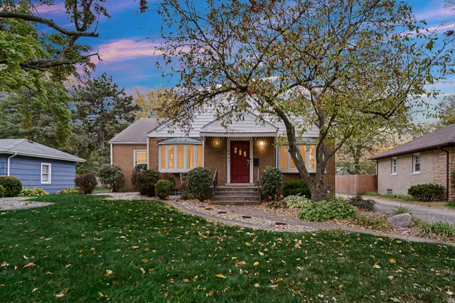 a front view of a house with a yard and outdoor seating