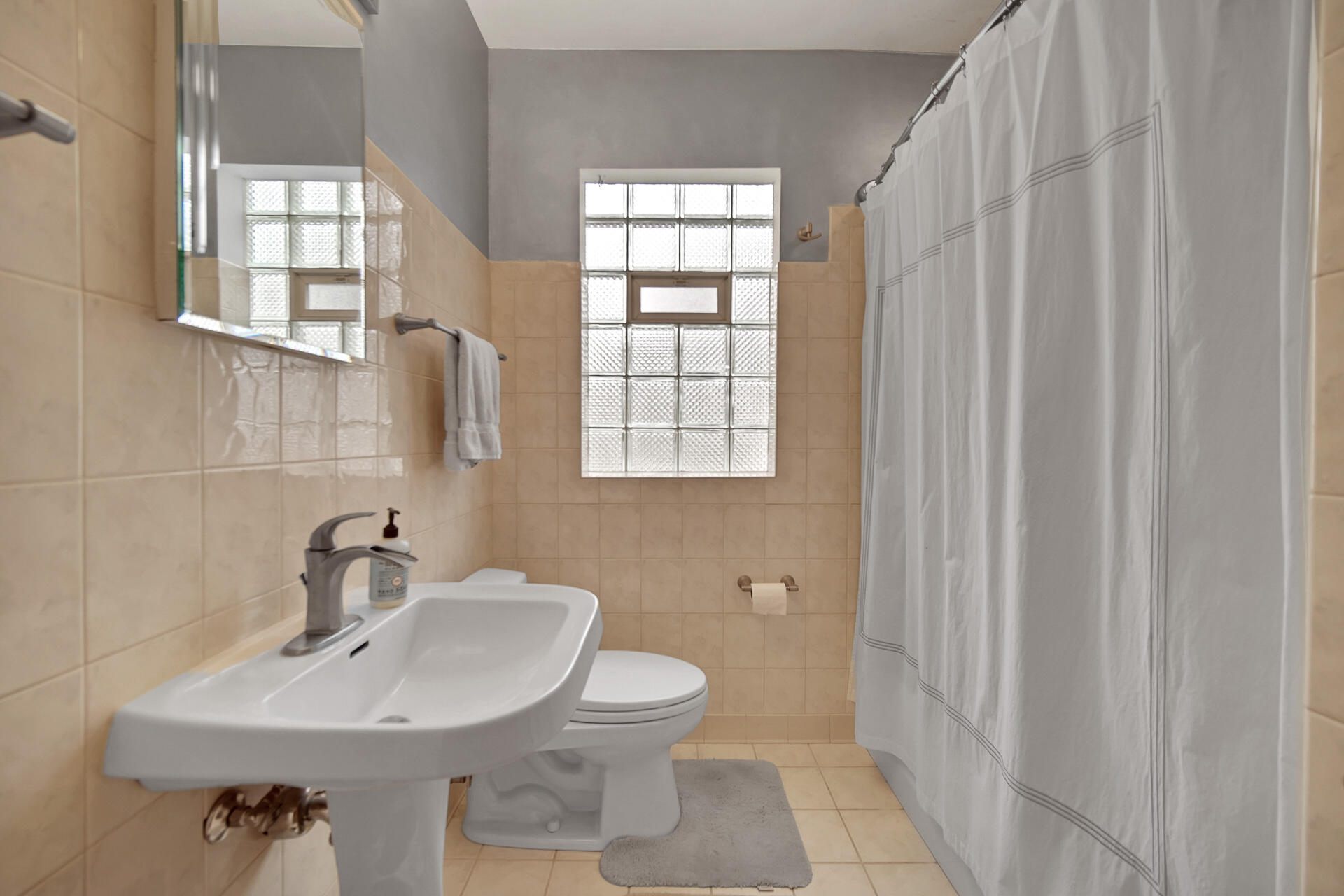8342 Howard Avenue Munster, IN 46321 - Photo 14 of 31 a bathroom with a sink a toilet and a window