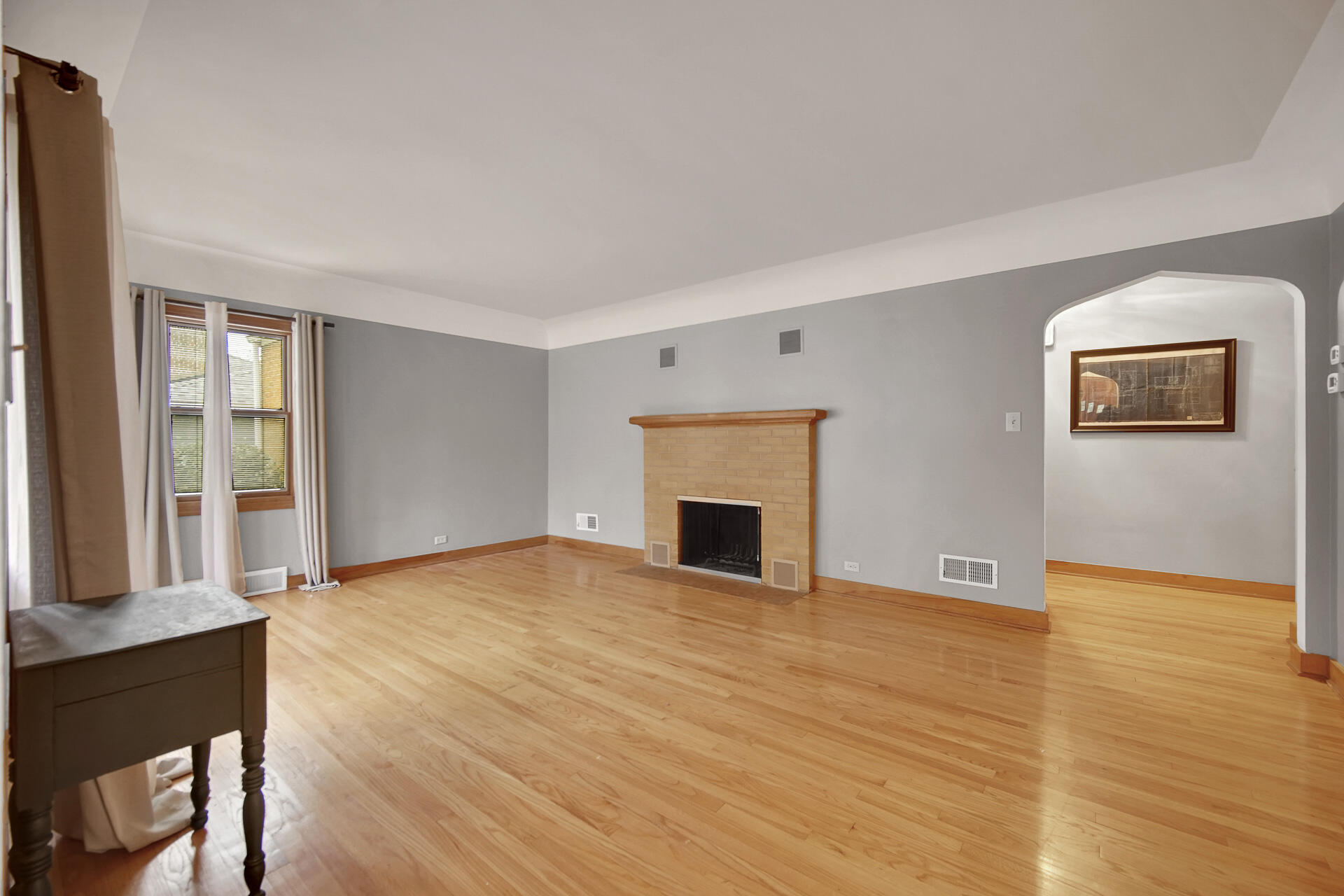 8342 Howard Avenue Munster, IN 46321 - Photo 3 of 31 a view of an empty room with wooden floor and a window
