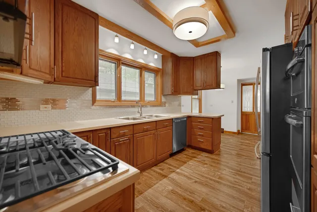 a kitchen with stainless steel appliances granite countertop a stove and a refrigerator