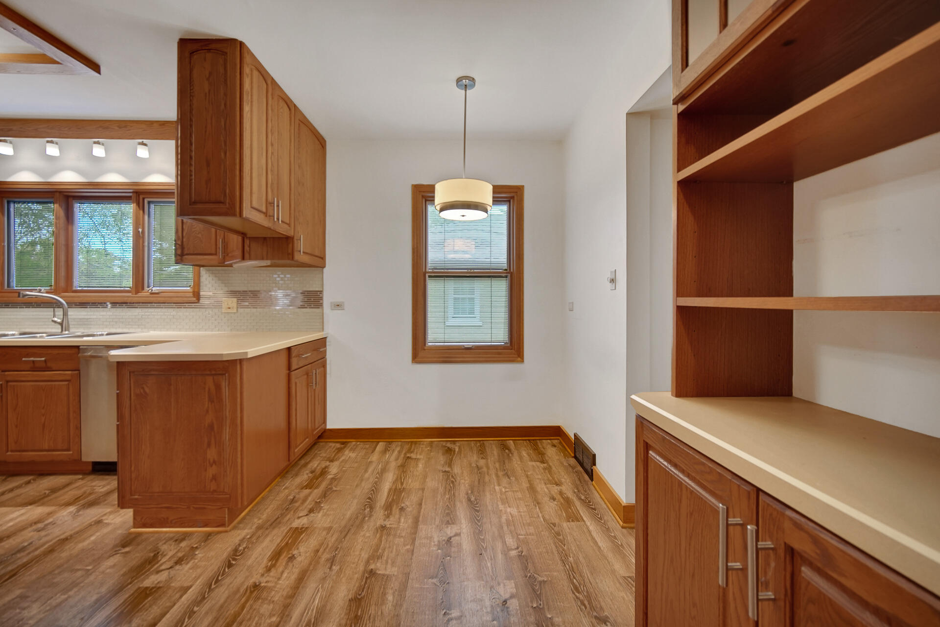 8342 Howard Avenue Munster, IN 46321 - Photo 10 of 31 a kitchen with a sink cabinets and wooden floor
