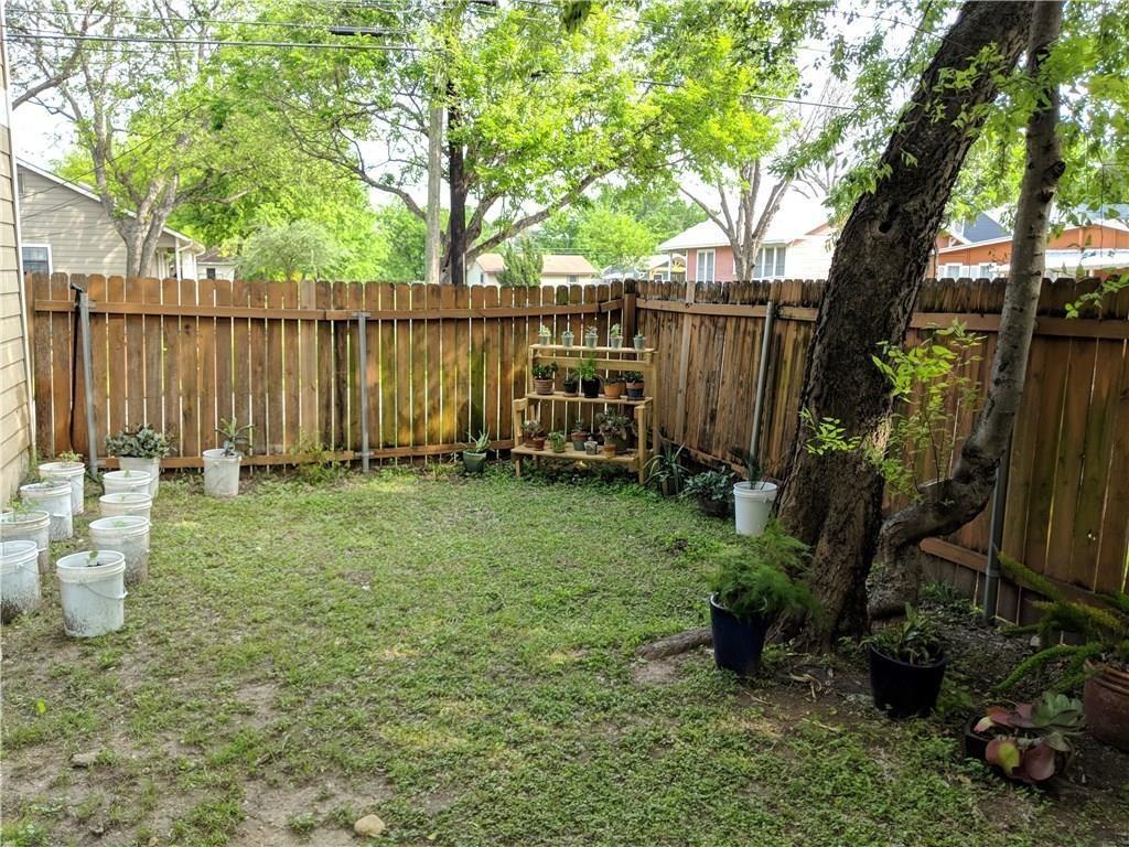 5501 Duval Street, Unit B Austin, TX 78751 - Photo 12 of 12 a view of a backyard with wooden fence and a large tree
