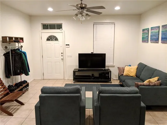 a living room with furniture and a flat screen tv