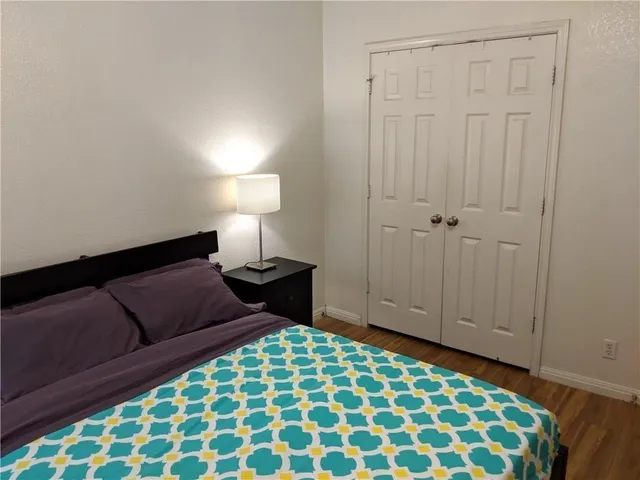 a bedroom with a bed and a lamp