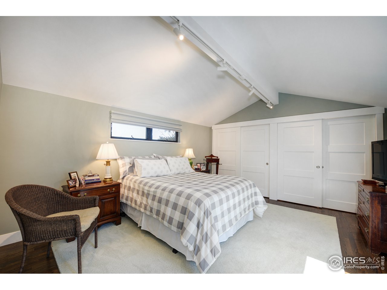 742 8th Street Boulder, CO 80302 - Photo 19 of 37 a bedroom with a bed and a chair