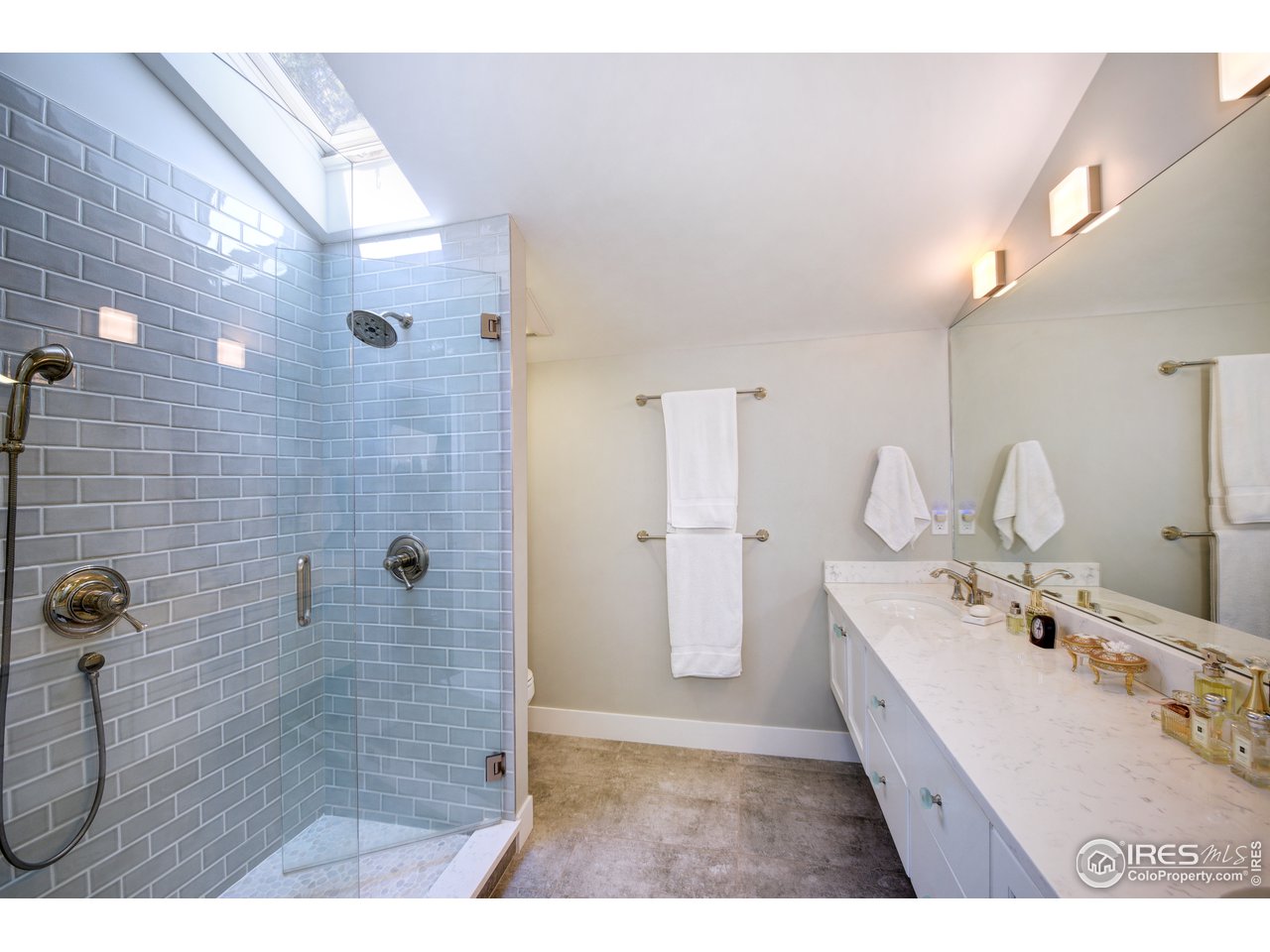 742 8th Street Boulder, CO 80302 - Photo 20 of 37 a bathroom with a double vanity sink a mirror and a shower