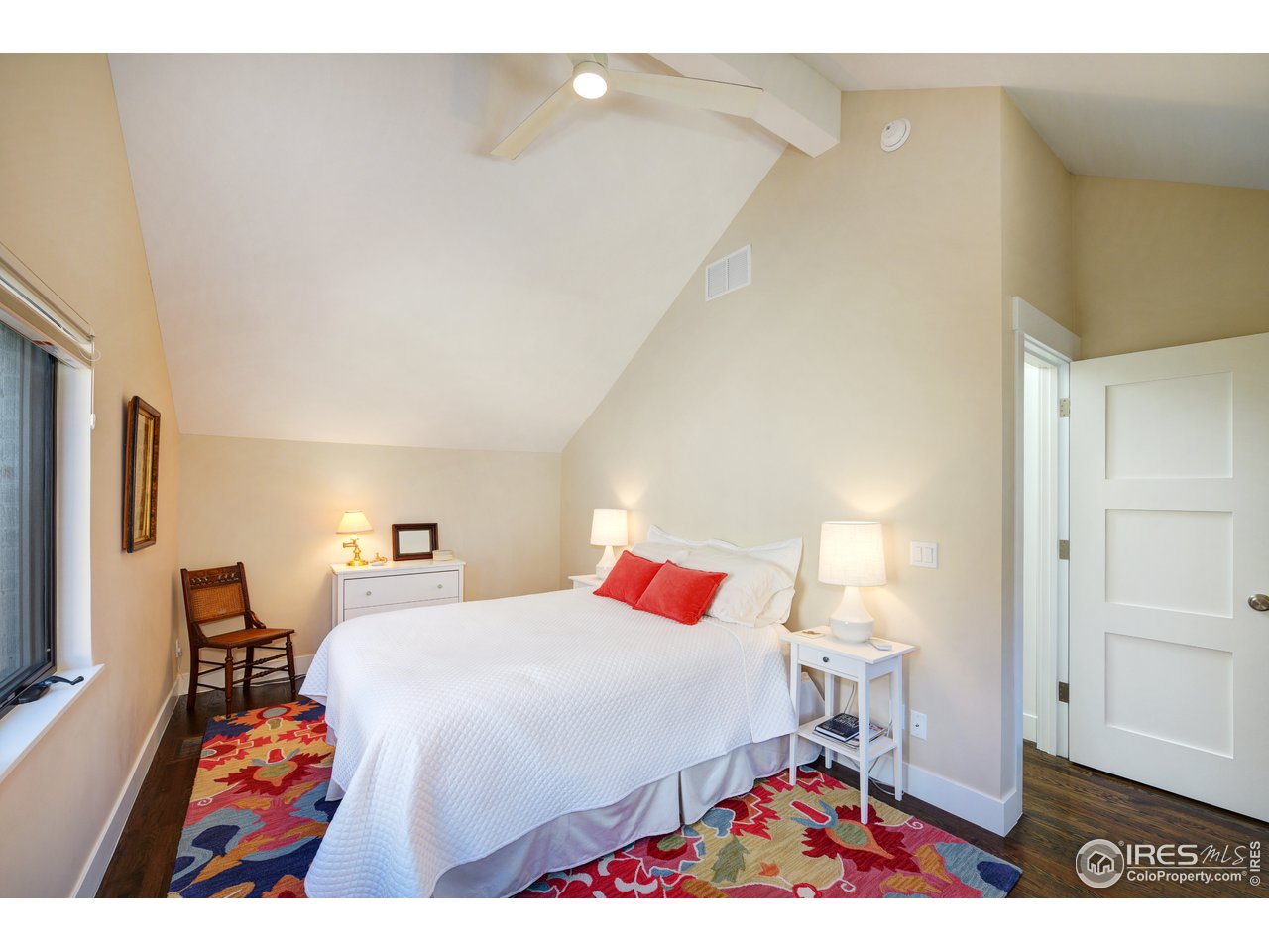 742 8th Street Boulder, CO 80302 - Photo 22 of 37 a bedroom with a bed and wooden floor