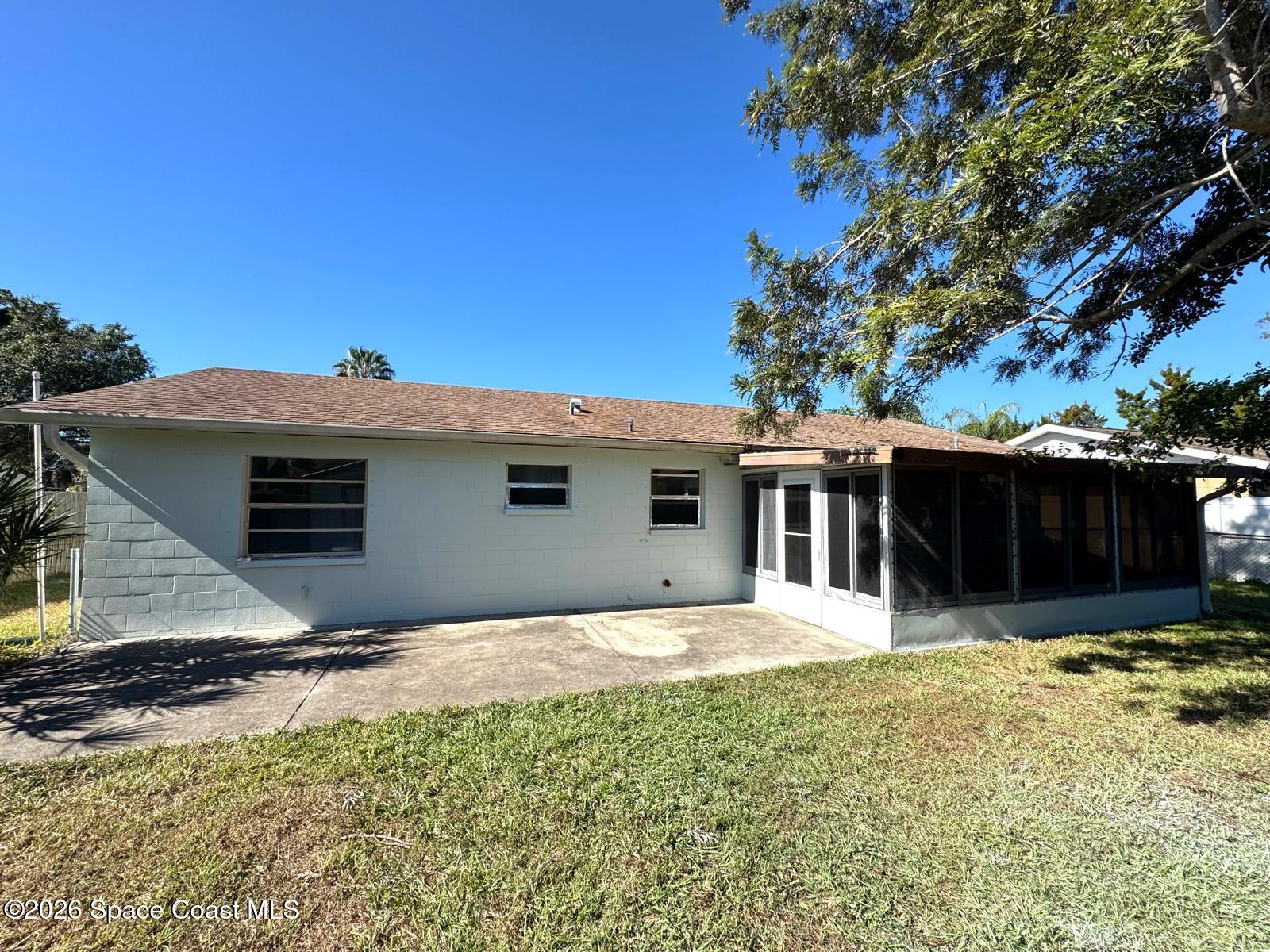 518 Sylvia Road Melbourne, FL 32904 - Photo 15 of 18 a house with trees in the background
