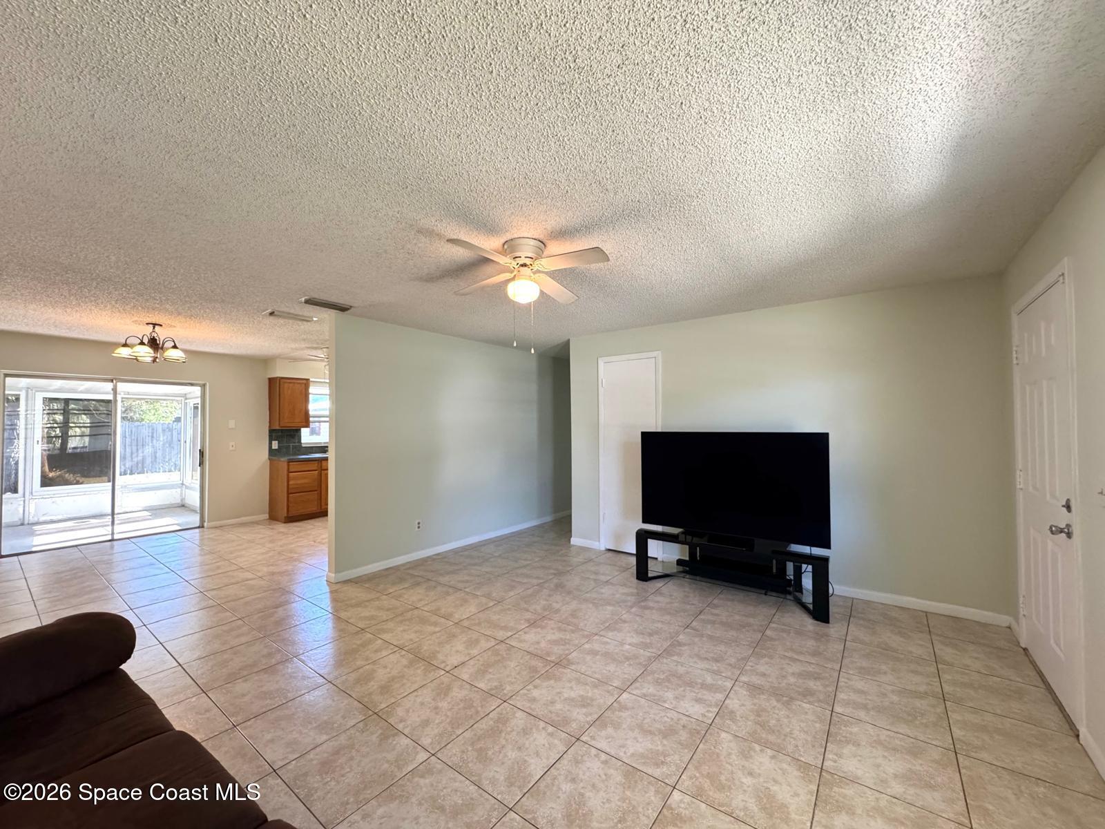 518 Sylvia Road Melbourne, FL 32904 - Photo 2 of 18 a living room with furniture and a flat screen tv