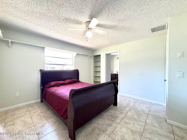 a bedroom with a bed and window