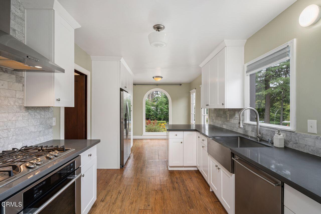 2107 Minoru Drive Altadena, CA 91001 - Photo 11 of 29 a kitchen with a sink stove top oven and cabinets