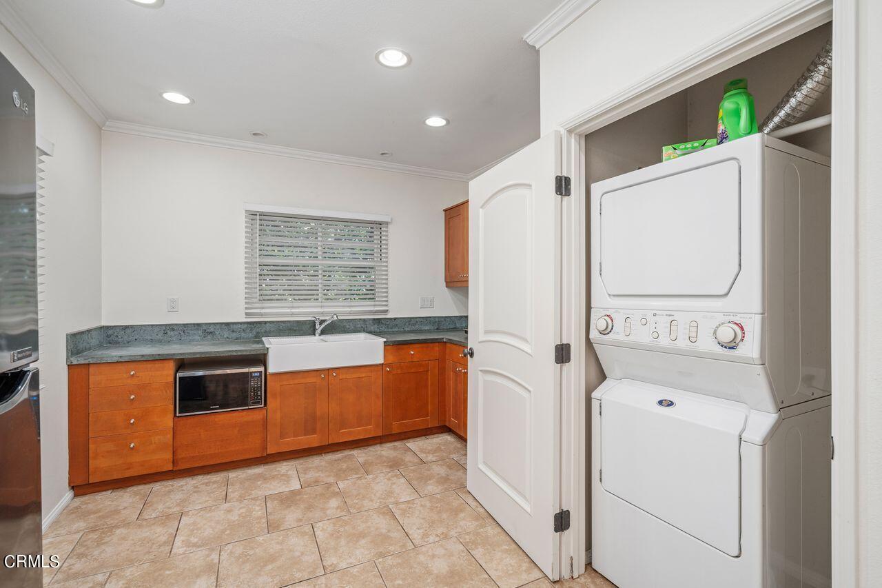 2107 Minoru Drive Altadena, CA 91001 - Photo 29 of 29 a kitchen with stainless steel appliances granite countertop a refrigerator a stove and a sink