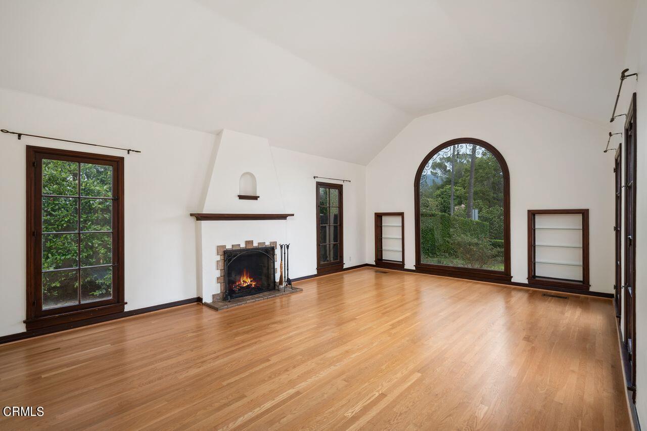 2107 Minoru Drive Altadena, CA 91001 - Photo 6 of 29 a view of an empty room with wooden floor fireplace and a window