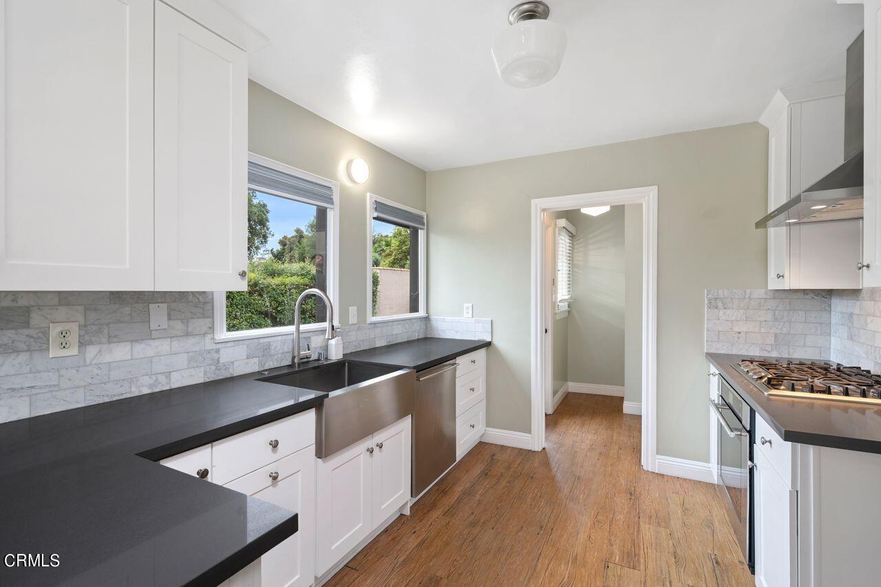 2107 Minoru Drive Altadena, CA 91001 - Photo 10 of 29 a kitchen with granite countertop a sink a counter space appliances and cabinets