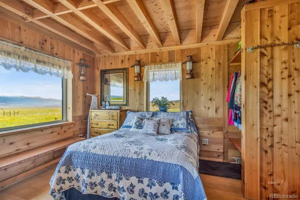 a bedroom with a large bed and a large window