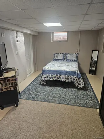 a bedroom with a bed rug and dresser