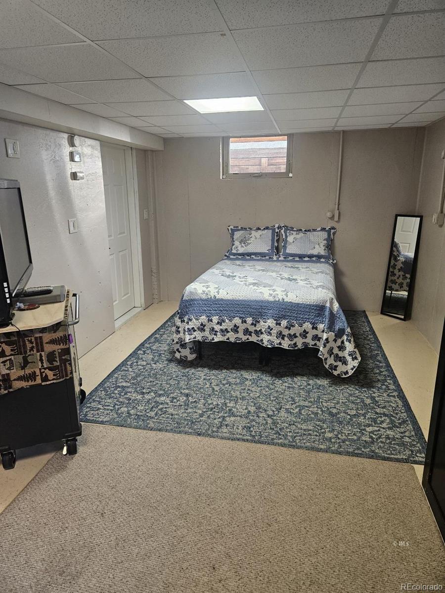 535 Brittany Road Westcliffe, CO 81252 - Photo 18 of 31 a bedroom with a bed rug and dresser