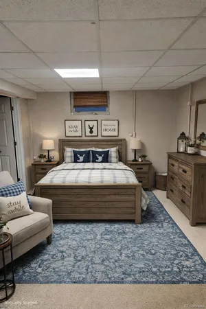 a spacious bedroom with a bed a couch and dresser