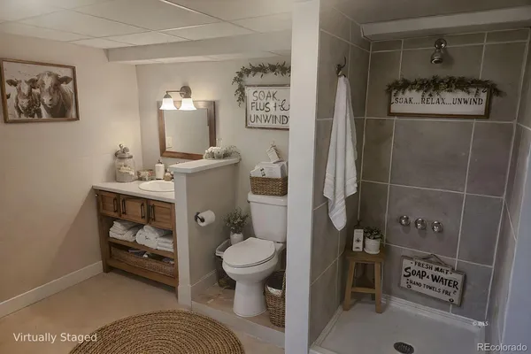 a bathroom with a toilet and a shower curtain