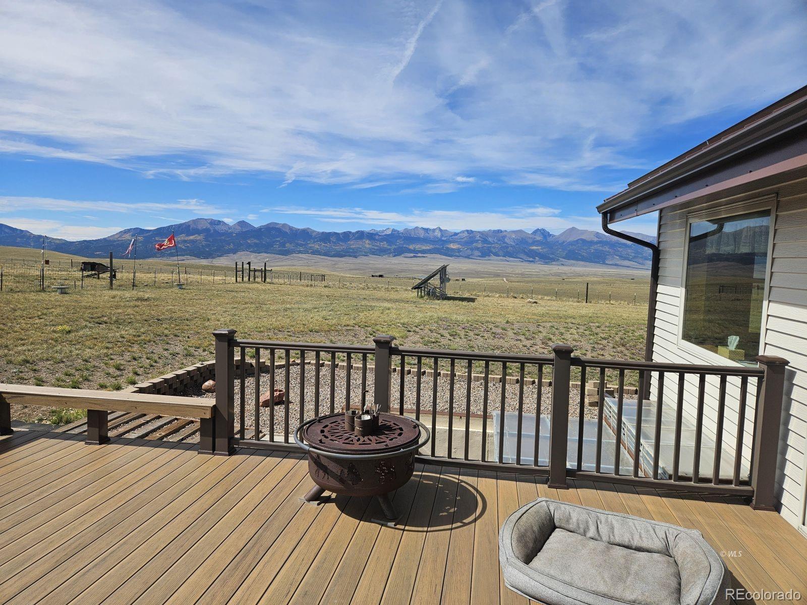 535 Brittany Road Westcliffe, CO 81252 - Photo 28 of 31 a view of a roof deck with wooden floor and a chairs