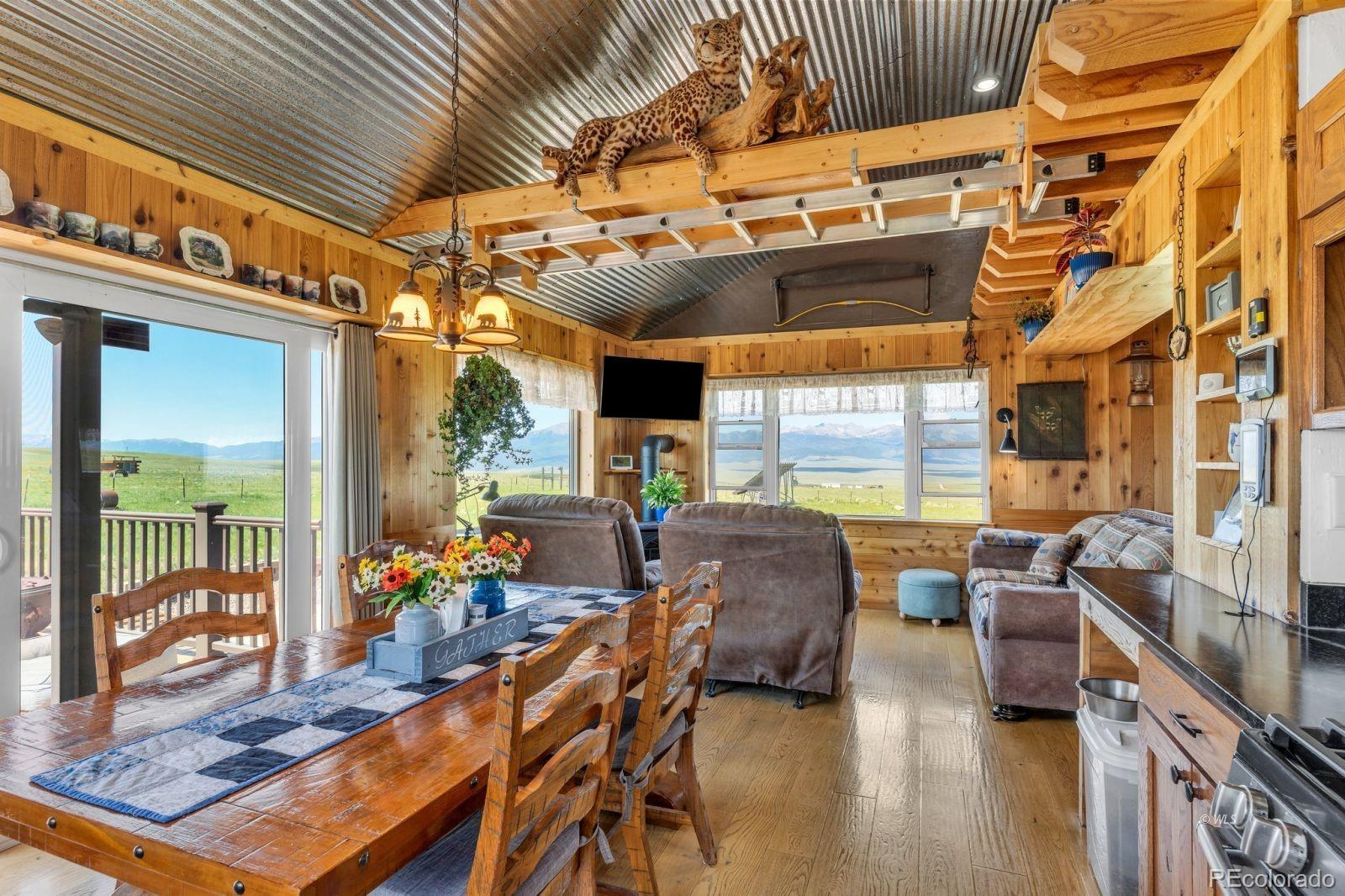 535 Brittany Road Westcliffe, CO 81252 - Photo 7 of 31 a view of a patio with table and chairs potted plants with wooden floor