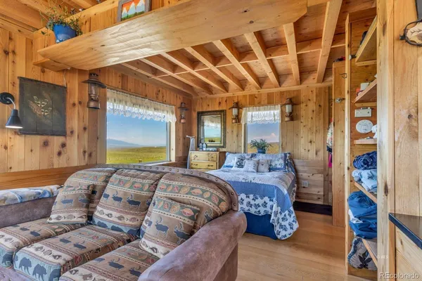 a large bed sitting in a bedroom next to a window