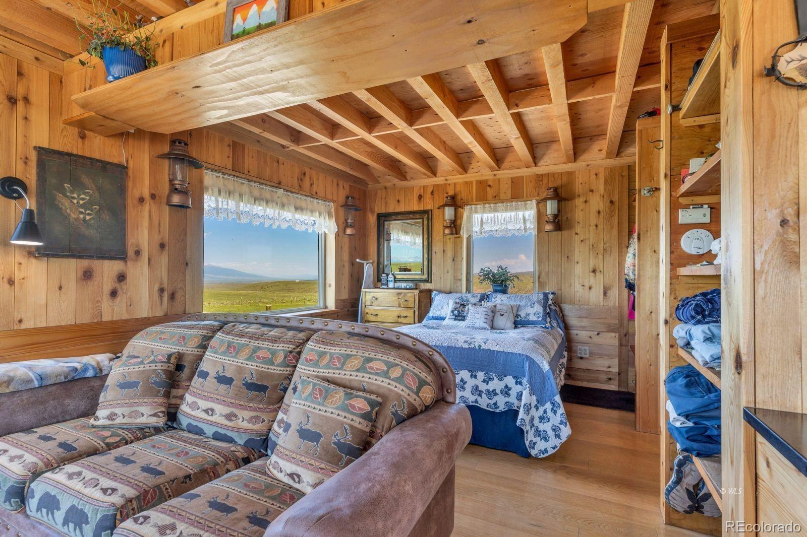 535 Brittany Road Westcliffe, CO 81252 - Photo 10 of 31 a large bed sitting in a bedroom next to a window