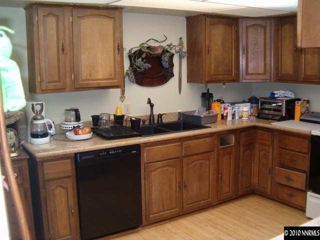 1290 Manhattan Street Reno, NV 89512 - Photo 4 of 9 a kitchen with stainless steel appliances granite countertop a sink dishwasher stove and cabinets
