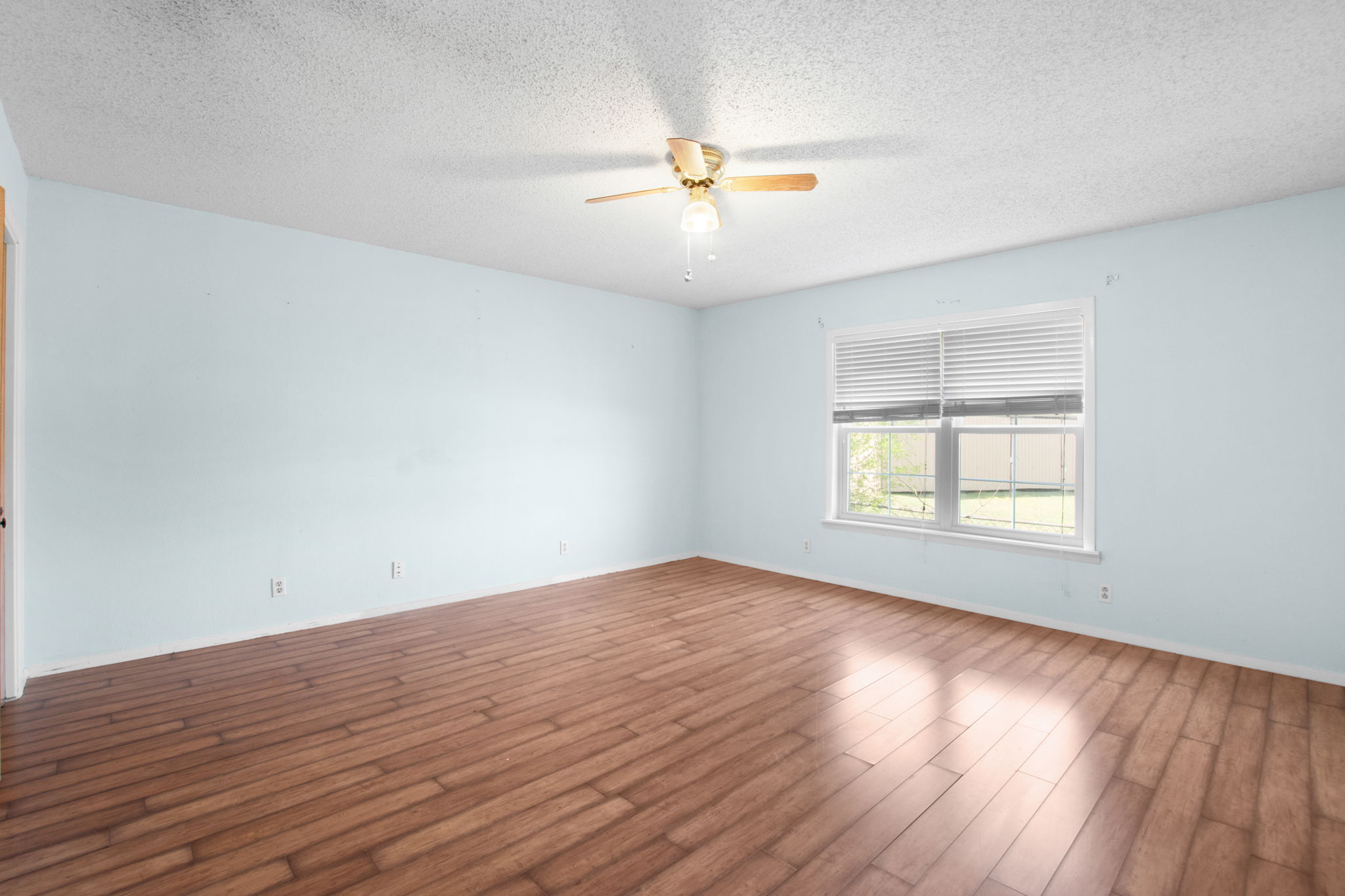 112 Frazier Tow, TX 78672 - Photo 17 of 30 Spare room with a textured ceiling, baseboards, ceiling fan, and wood finished floors