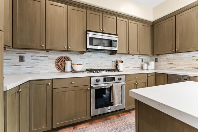 a kitchen with a sink stove and microwave