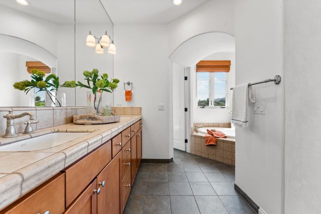 a bathroom with a granite countertop sink a toilet and a mirror
