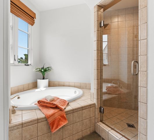 a bath room with a bath tub and shower