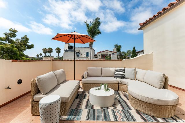 a balcony with furniture and a potted plant