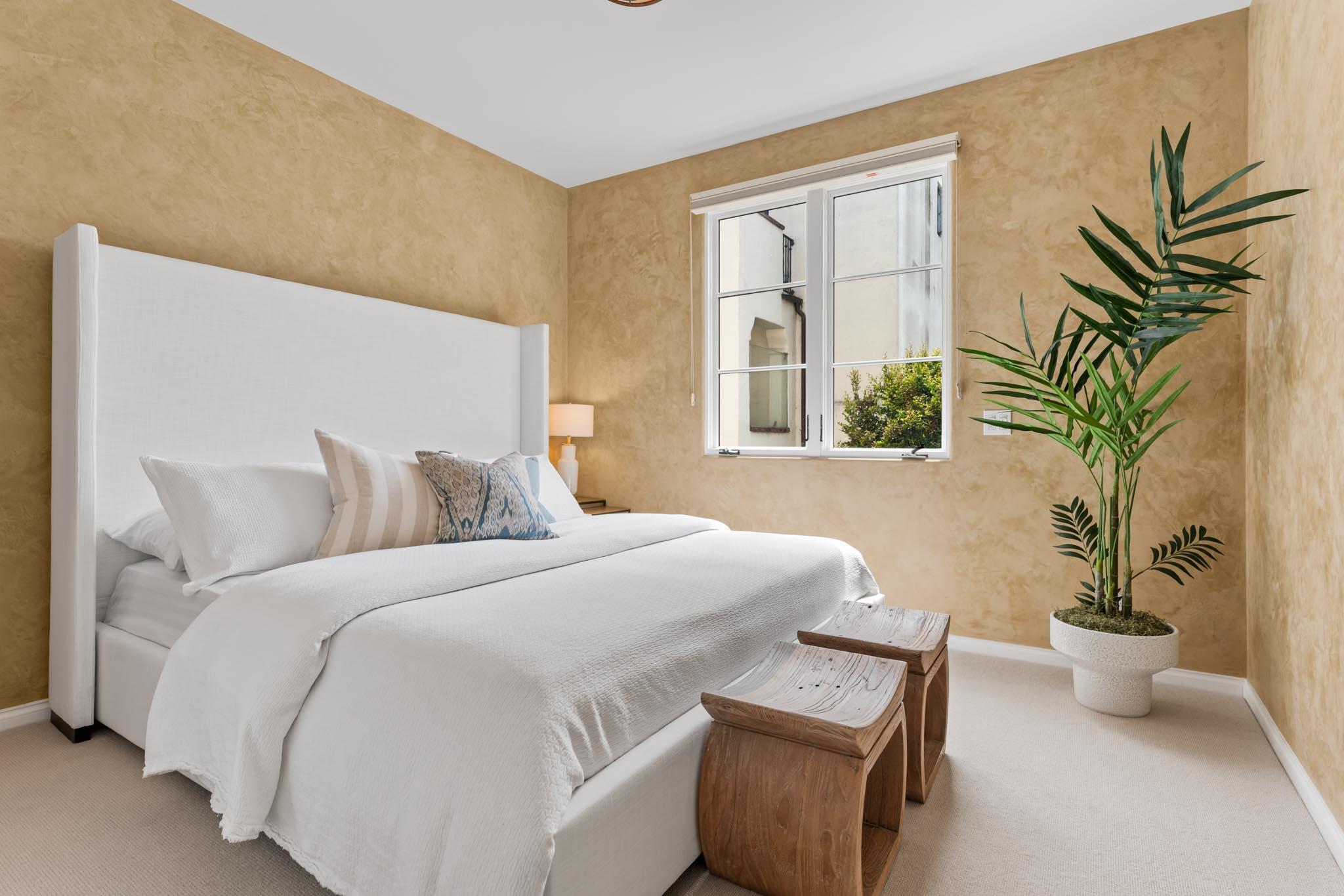 212 Santa Barbara Street, Unit B Santa Barbara, CA 93101 - Photo 18 of 28 a bedroom with a bed and a potted plant