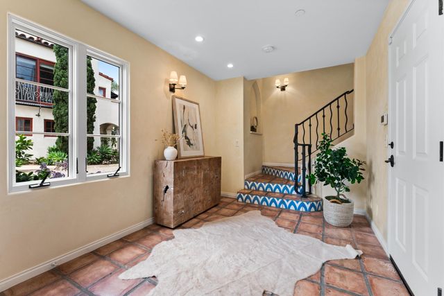 a hallway with beautiful frames and flower vase