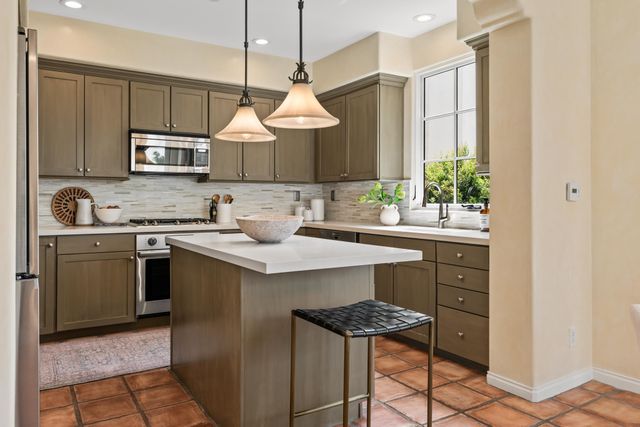 a kitchen with a sink stove and microwave