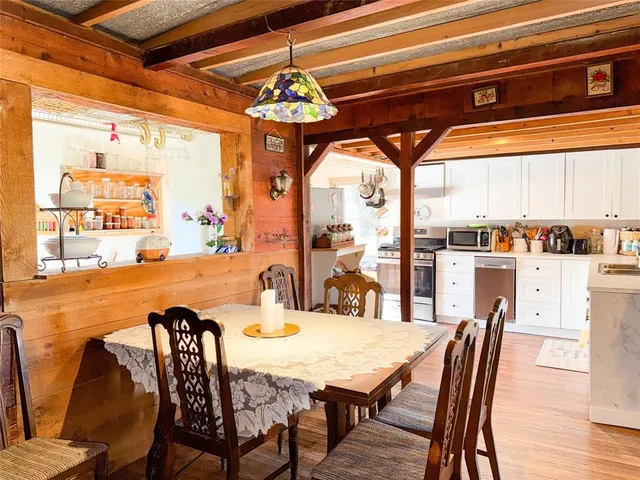 a dining table with chairs and window