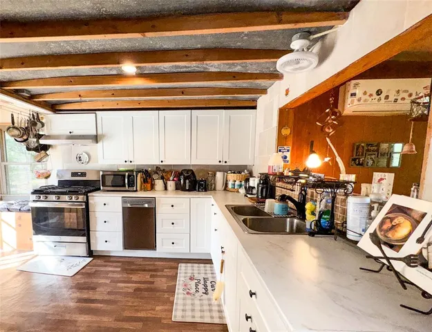 a kitchen with a stove a refrigerator and cabinets