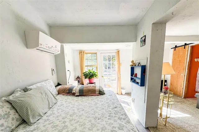 a bedroom with furniture and a window