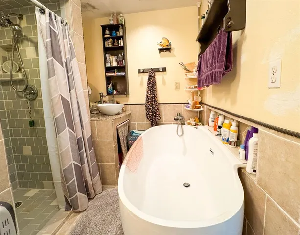 a bathroom with a bathtub and shower