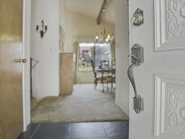 a dining room with furniture potted plants and wooden floor