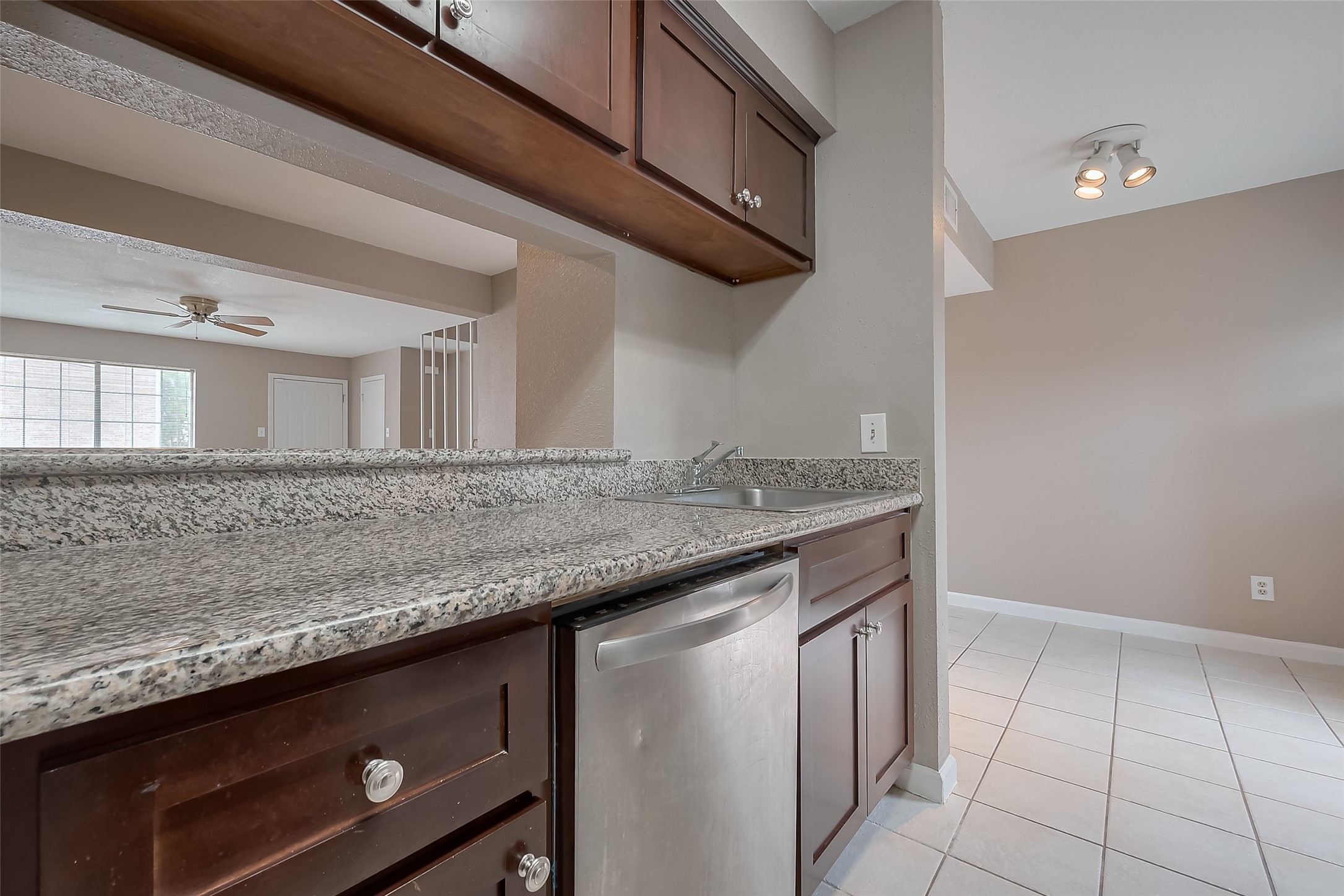 6111 Beverly Hill Street, Unit 29 Houston, TX 77057 - Photo 8 of 22 a kitchen with granite countertop a sink and a white stove