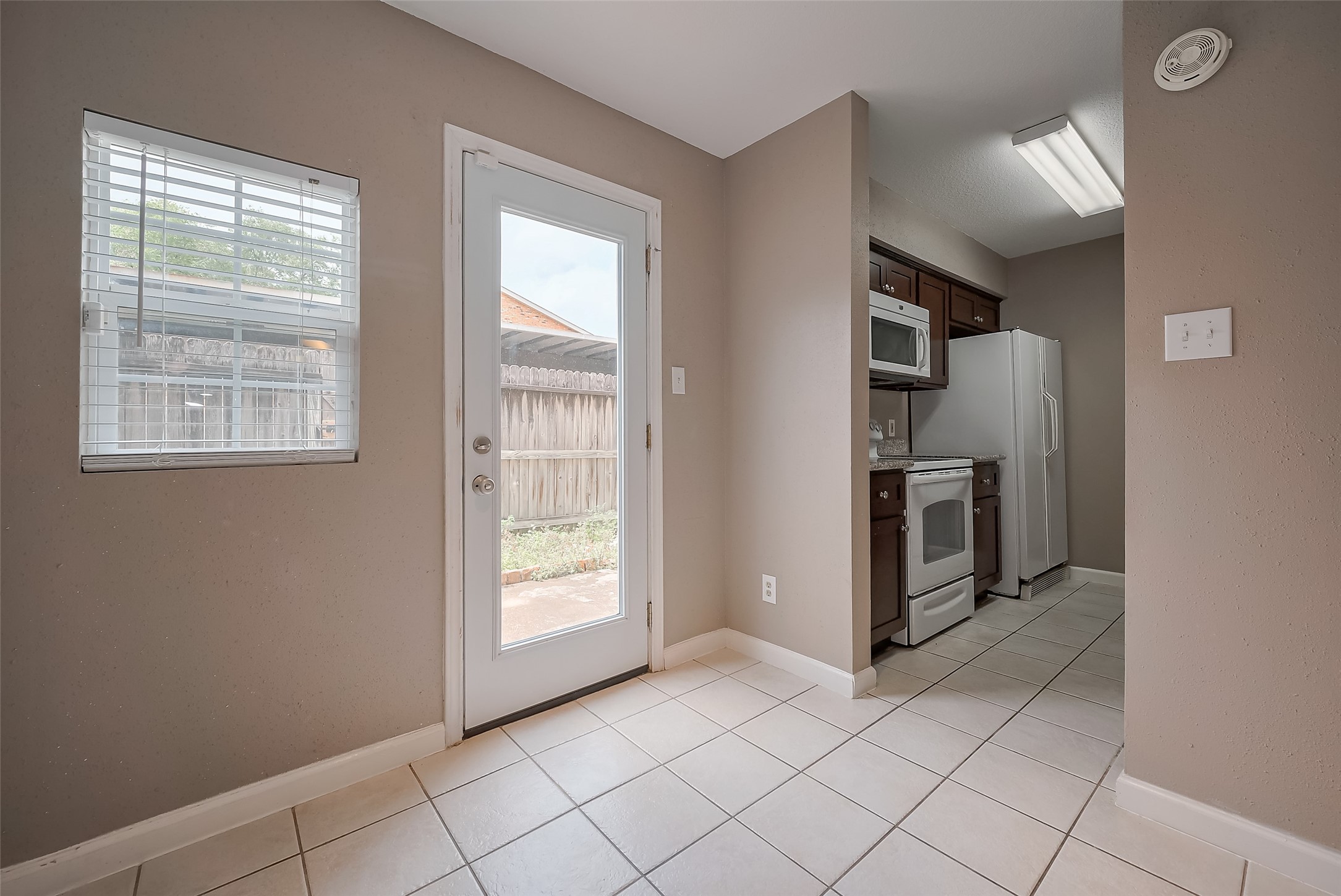 6111 Beverly Hill Street, Unit 29 Houston, TX 77057 - Photo 9 of 22 an empty room with kitchen view and a window